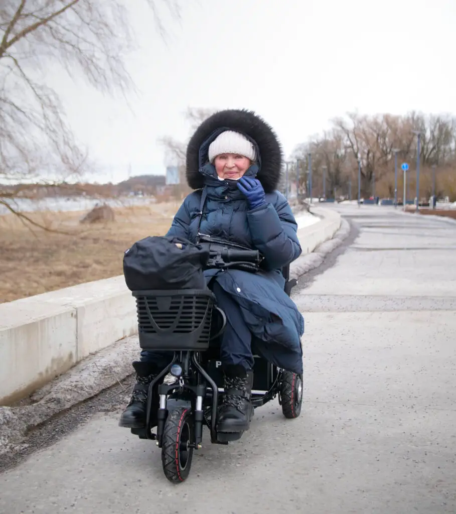 Senior elderly person riding Pinge Tricycle electric mobility scooter tricycle outdoor